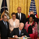 US President Joe Biden (C) participates in a signing ceremony in the East Room of the White House in Washington, DC, on May 25, 2022. - Biden signed an Executive Order to advance policing and strengthen public safety.